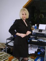 Blonde office MILF strips and spreads her ivory legs