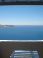 Kelly is playing with herself in Santorini in a blue poka dot bikini.