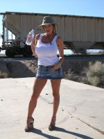 Kelly shows off her super hot tits in the middle of the desert.